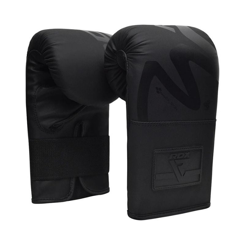 The RDX - Noir F15 Bag Gloves 4oz Black feature ConvEX Skin Combat Leather for superior impact protection, a wrist strap for secure fit, and subtle front logo detailing in a matte black finish.