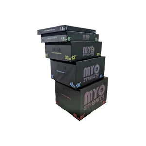 Five black MYO Strength Soft Plyometric Platform Boxes (7.5–60cm) are stacked by size, each labeled in cm/inch, perfect for jump training. This is the stackable 5-piece kit by MYO Strength.