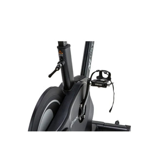 The Attack Fitness M1 Magnetic Studio Bike by Attack Fitness is a black belt-driven indoor cycle with console, featuring an adjustable seat, handlebars, and large flywheel—ideal for indoor cycling workouts against a white background.