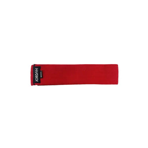 The JORDAN Fabric Resistance Band in red is a non-slip booty band for squats, lunges, and glute workouts, featuring a black label with "JORDAN" text on a white background.