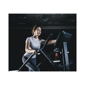 Woman exercising on a Stair Climber in a gym setting