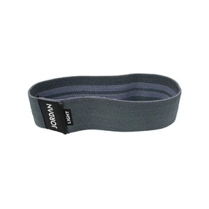 The JORDAN Fabric Resistance Band in grey is a non-slip booty band for squats, lunges, and glute workouts, featuring a black label with "JORDAN" text on a white background.