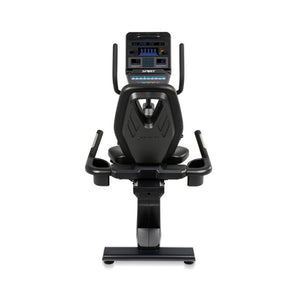 Black exercise bike with digital display on a white background