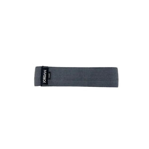 The JORDAN Fabric Resistance Band in grey is a non-slip booty band for squats, lunges, and glute workouts, featuring a black label with "JORDAN" text on a white background.