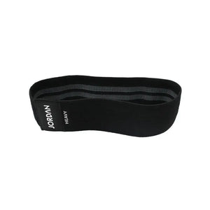 The JORDAN Fabric Resistance Band in black is a non-slip booty band for squats, lunges, and glute workouts, featuring a black label with "JORDAN" text on a white background.