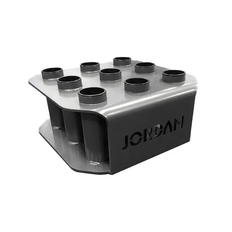 The JORDAN Olympic Bar Holder by Jordan is a black, rectangular rack with nine vertical slots for organizing Olympic bars upright, featuring the brand name cut out on the side.