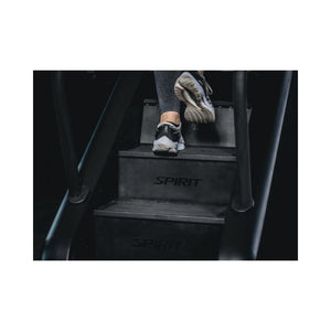 Person stepping onto a Stair Climber with 'Spirit' branding