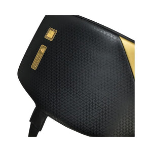 Close-up of a black sports bag with a subtle geometric pattern, gold accents, and a small gold label. A black strap is partially visible at the bottom left.