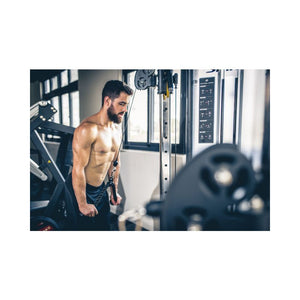 Man standing in a gym with exercise equipment in the background