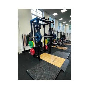 The JORDAN J75 Adjustable T Rack Cable Machine is a black all-in-one pulley and power rack system with Jordan-branded blue and red weight plates—perfect for versatile strength training using cables, pulleys, and bars.