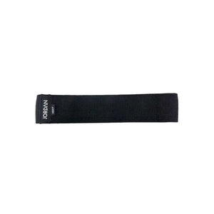 The JORDAN Fabric Resistance Band in black is a non-slip booty band for squats, lunges, and glute workouts, featuring a black label with "JORDAN" text on a white background.