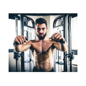 Man exercising with a cable machine in a gym setting
