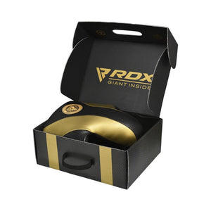 A black and gold RDX branded boxing headguard is displayed inside an open black box with gold accents and the RDX logo on the lid.