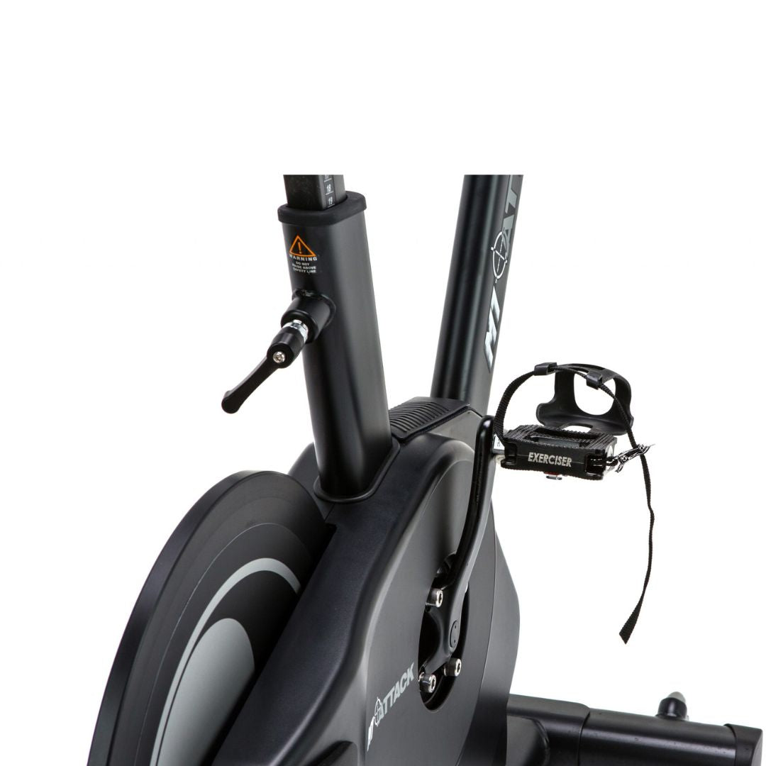 The ATTACK FITNESS -Spin Attack M1 by Attack Fitness is a sleek black indoor cycling bike on a white background. It features magnetic resistance, a digital display on the handlebars, an adjustable seat, and pedals with straps, showcasing its modern, commercial-grade fitness design.