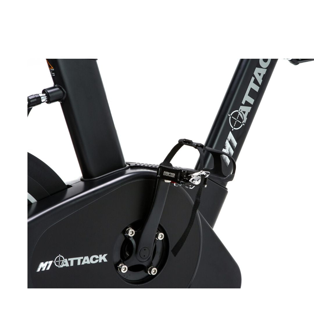 The ATTACK FITNESS -Spin Attack M1 by Attack Fitness is a sleek black indoor cycling bike on a white background. It features magnetic resistance, a digital display on the handlebars, an adjustable seat, and pedals with straps, showcasing its modern, commercial-grade fitness design.