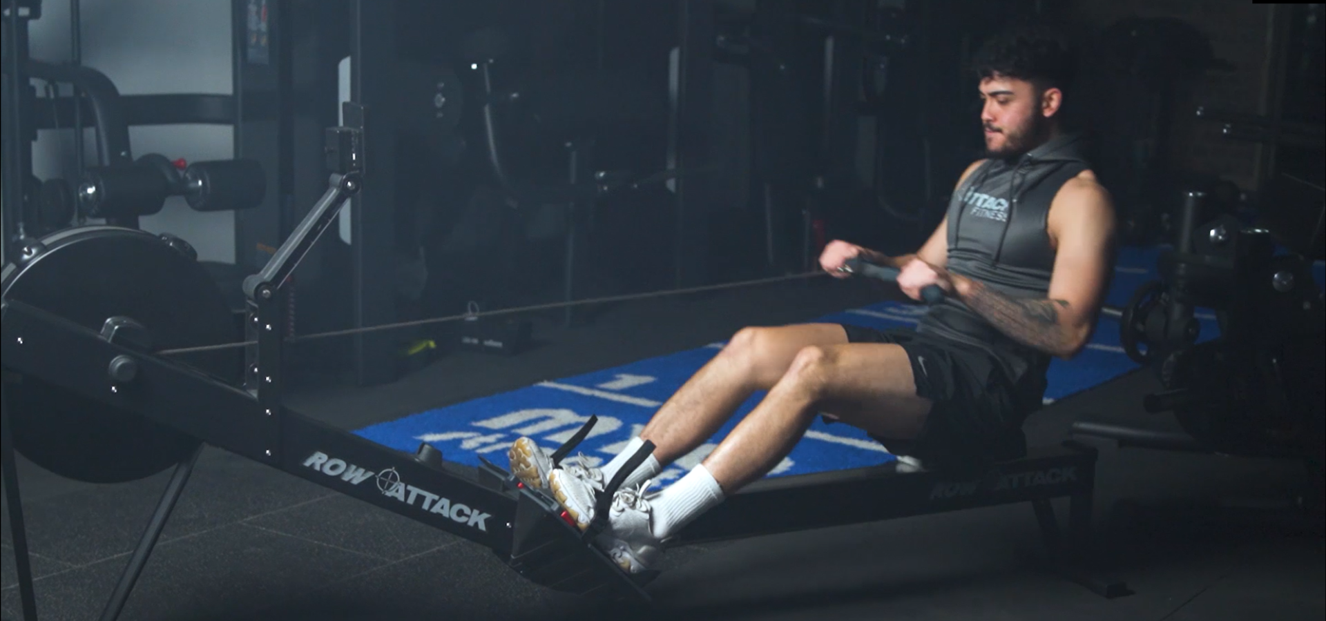 Man using a rowing machine in a gym setting