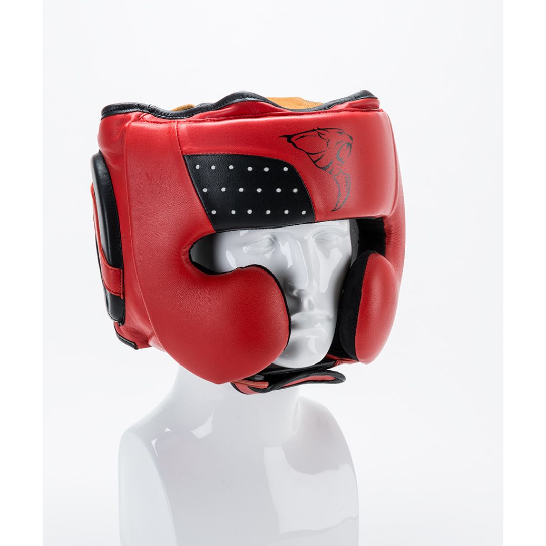 The CARBON CLAW - PRO X-ILD leather headguard by Carbon Claw is shown on a white mannequin. It features advanced impact absorption technology, a red exterior with a black lining, and displays the logo on the side against a plain background.
