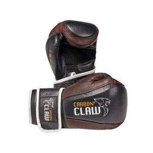 A pair of black and brown Carbon Claw RB-7 Leather Bag Gloves with gel-lined protection are displayed on a white background—one upright, one flat showing the Carbon Claw logo. Ergonomic design offers excellent wrist support for boxing training.