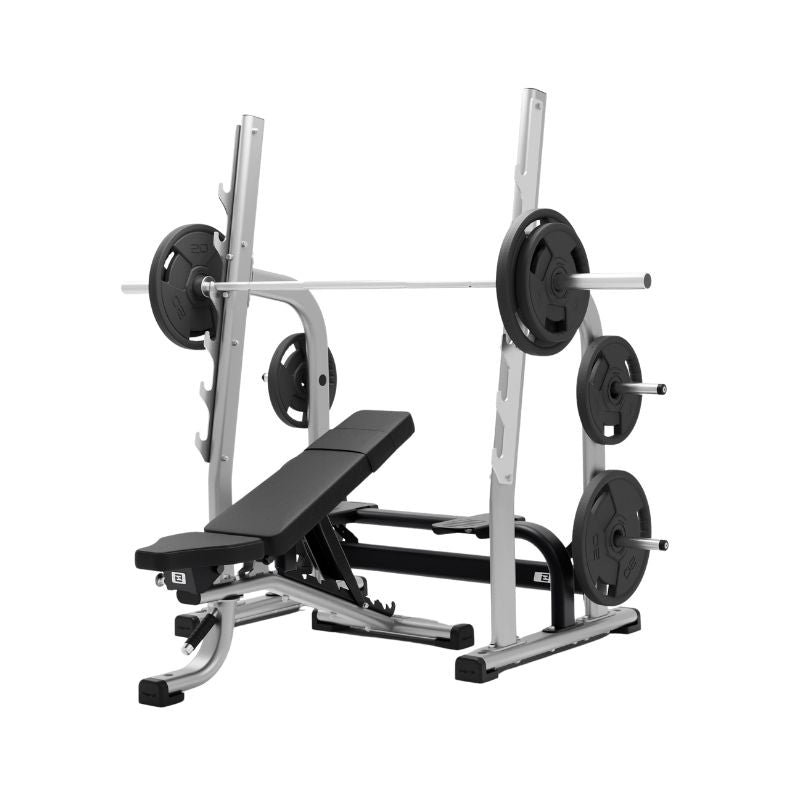 The Exigo EXIGO Adjustable Olympic Bench – Commercial Barbell Bench, in silver and black, features a barbell with weight plates on a squat rack and side pegs. Ideal for barbell training and strength exercises.