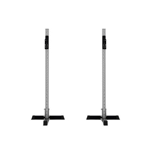 The Exigo X70 Free Standing Squat Stands by Exigo feature gray metal uprights with black bases, shown side by side on a plain white background—perfect for heavy barbell training at home.
