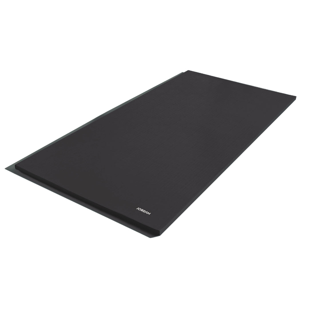 A black rectangular yoga mat is shown on a white background. It has a subtle texture and non-slip design, with Jordan printed near one edge. The product is called JORDAN - 40mm Multi Purpose Non Slip Stretch Mats (Ex Demo).