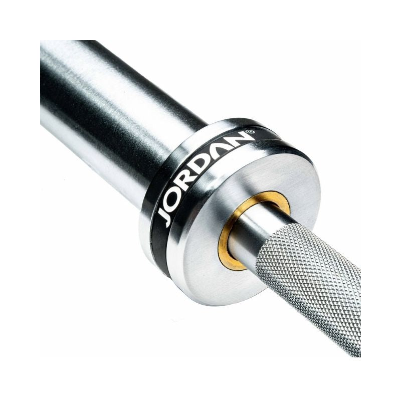 Close-up of the JORDAN Elite Olympic Bar—20kg, 7ft, 185,000 PSI—with knurled grip and silver collar, displaying "Jordan" in bold white letters on black; a premium needle bearing bar ideal for serious weightlifting.