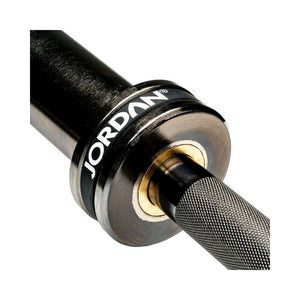 Close-up of the JORDAN Black Olympic "Shadow" Bar—a 7ft, titanium-coated barbell (20kg, 215K PSI, 900kg capacity)—showcasing its knurled grip and metallic sleeve with the Jordan brand on the black collar for powerlifting.