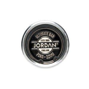 Top view of the round, silver and black end cap on the Jordan Ultimate Olympic Bars—Men’s & Women’s Competition-Standard Barbells (15kg/20kg)—built for rigorous use and labeled “Ultimate Bar, ESTD 1989, Jordan, England, 20KG - 32MM.”.