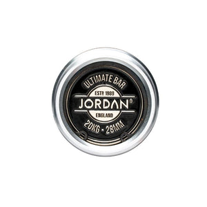 Close-up top view of a JORDAN Ultimate Olympic Bar end cap, labeled with the brand name and weight—20KG, 28MM—with a black center and silver outer ring; perfect for men’s & women’s competition-standard barbells.