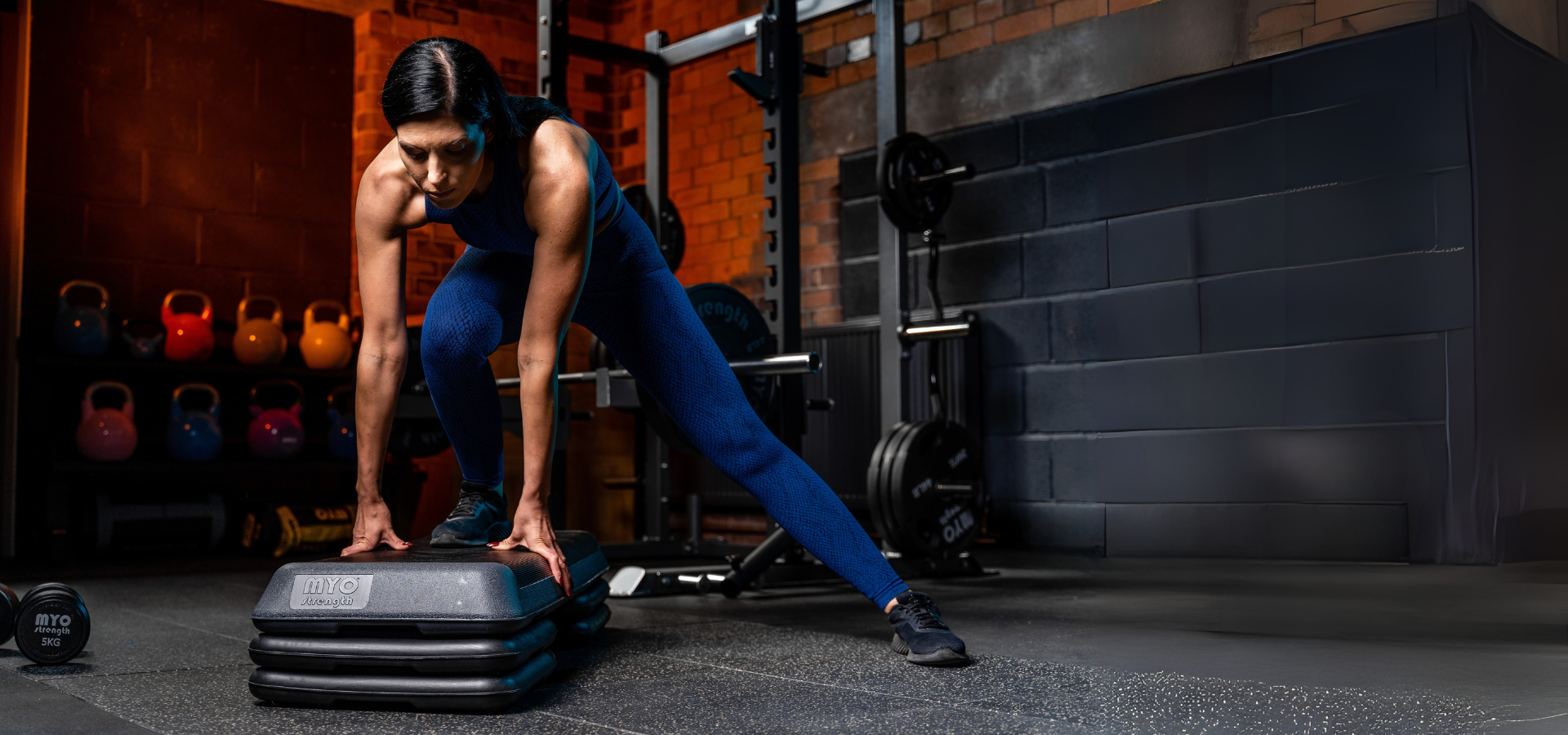 Person performing a workout with step platforms in a gym setting