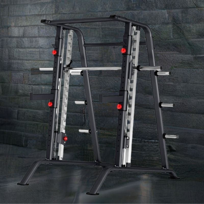 The MYO Strength - Smith Machine by MYO Strength is a black and gray resistance training powerhouse featuring a barbell with adjustable hooks, sturdy frame, red adjustment knobs, and multiple storage pegs for weight plates on a white backdrop.