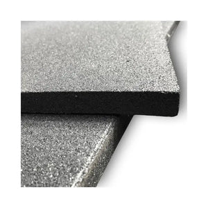 Close-up of two stacked MYO Strength Rubber Gym Flooring Tiles – Black (1000x1000x20mm) by MYO Strength, featuring a gray textured surface and straight edges, displayed diagonally against a white background for impact protection.