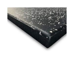 A close-up of the MYO Strength Rubber Gym Flooring Tile – Black with White Speckle (1000x500mm) shows its thickness, smooth yet slightly textured surface, and quality finish by MYO Strength.