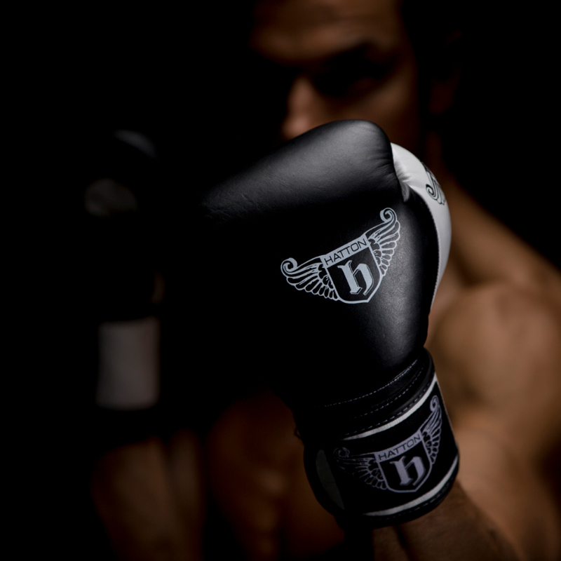 Black boxing glove with a brand logo on a blurred background