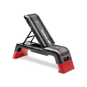 The Jordan Reebok Deck is an adjustable black and red fitness platform with a textured surface and sturdy legs, ideal for cardio and strength training at home or in the studio.