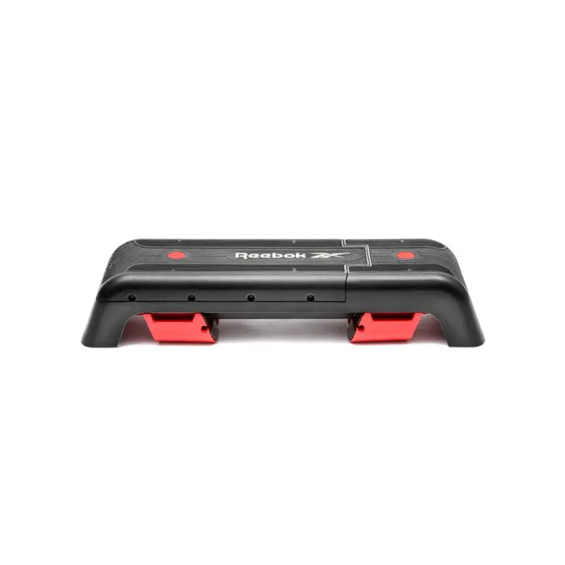 The Jordan Reebok Deck is an adjustable black and red fitness platform with a textured surface and sturdy legs, ideal for cardio and strength training at home or in the studio.