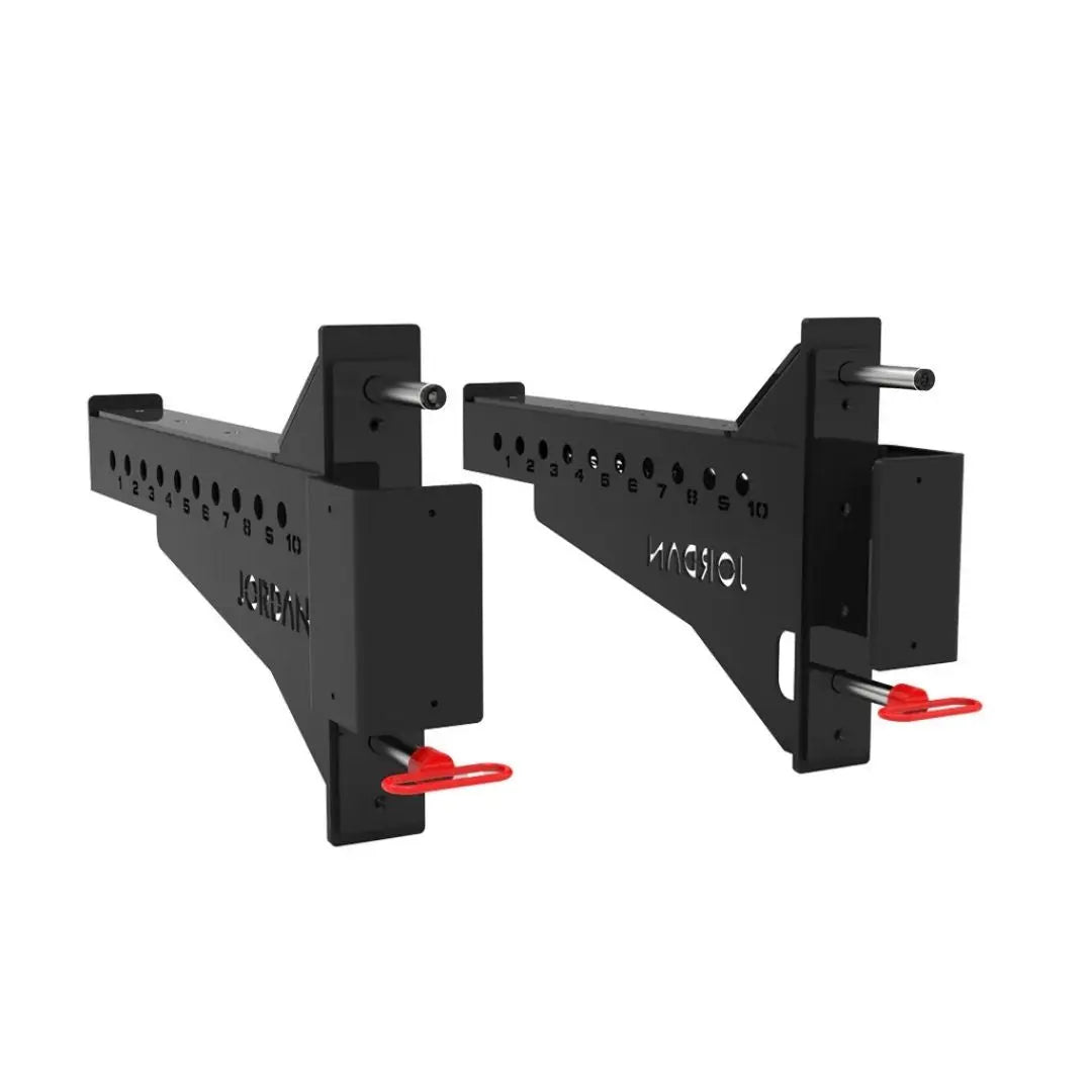 Positioned in parallel, the JORDAN J75 Safety Sport Arms Attachment (pair) features two black metal brackets with multiple holes, red wires, and an angled rectangular base. The Jordan brand name is visible in white, ensuring reliability for heavy lifting in strength training setups.