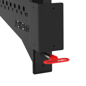 Positioned in parallel, the JORDAN J75 Safety Sport Arms Attachment (pair) features two black metal brackets with multiple holes, red wires, and an angled rectangular base. The Jordan brand name is visible in white, ensuring reliability for heavy lifting in strength training setups.