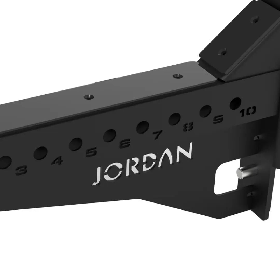 Positioned in parallel, the JORDAN J75 Safety Sport Arms Attachment (pair) features two black metal brackets with multiple holes, red wires, and an angled rectangular base. The Jordan brand name is visible in white, ensuring reliability for heavy lifting in strength training setups.