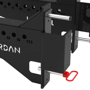 Positioned in parallel, the JORDAN J75 Safety Sport Arms Attachment (pair) features two black metal brackets with multiple holes, red wires, and an angled rectangular base. The Jordan brand name is visible in white, ensuring reliability for heavy lifting in strength training setups.