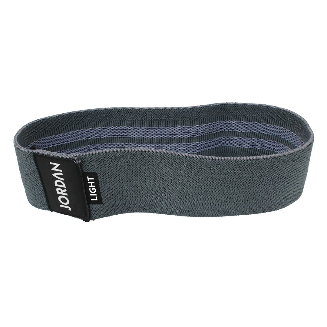 The JORDAN Fabric Resistance Band is red with Jordan and Medium on a black label, offering a smooth texture and moderate elasticity. Its durable design makes it perfect for fitness and strength training, providing versatile workout options.