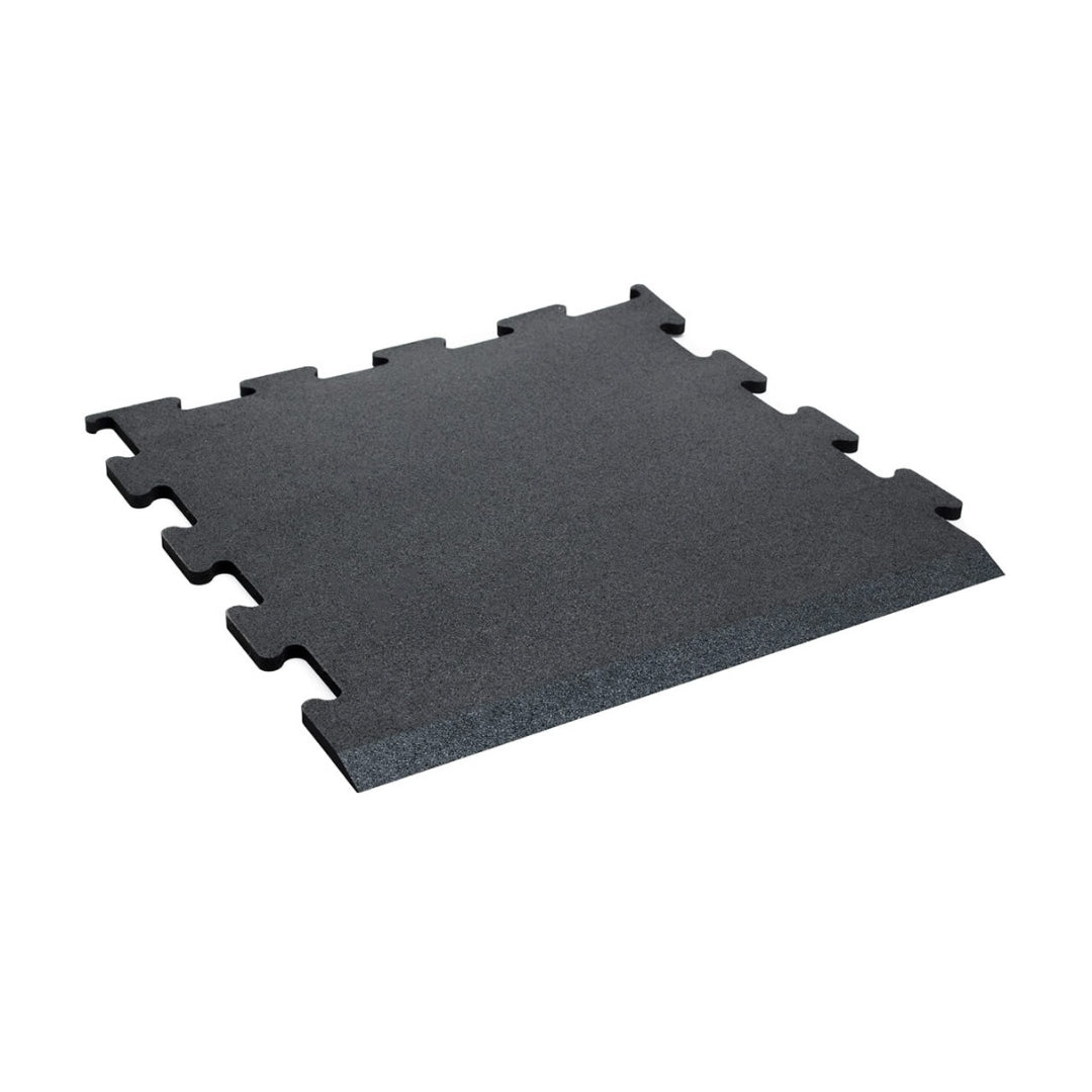 The JORDAN - ACTIV Gym Flooring Interlocking Mats - Black by Jordan are black rubber tiles with a textured surface, designed to connect seamlessly like puzzle pieces. Perfect for noise-reducing gym flooring, these tiles are set against a plain white background.