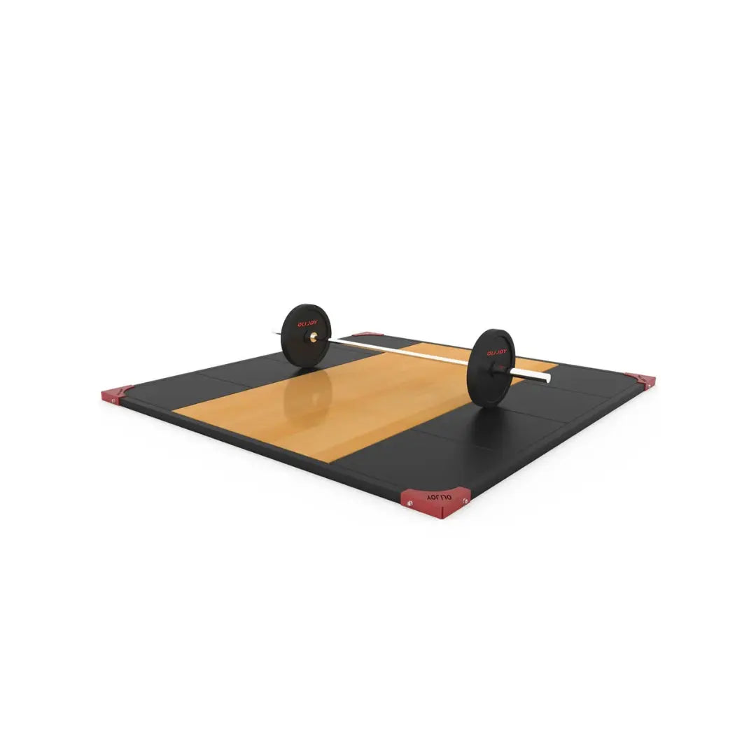 A weightlifting platform with a wooden center and black rubber sides, featuring a loaded barbell resting on top. The platform has red corner accents and is set against a white background.