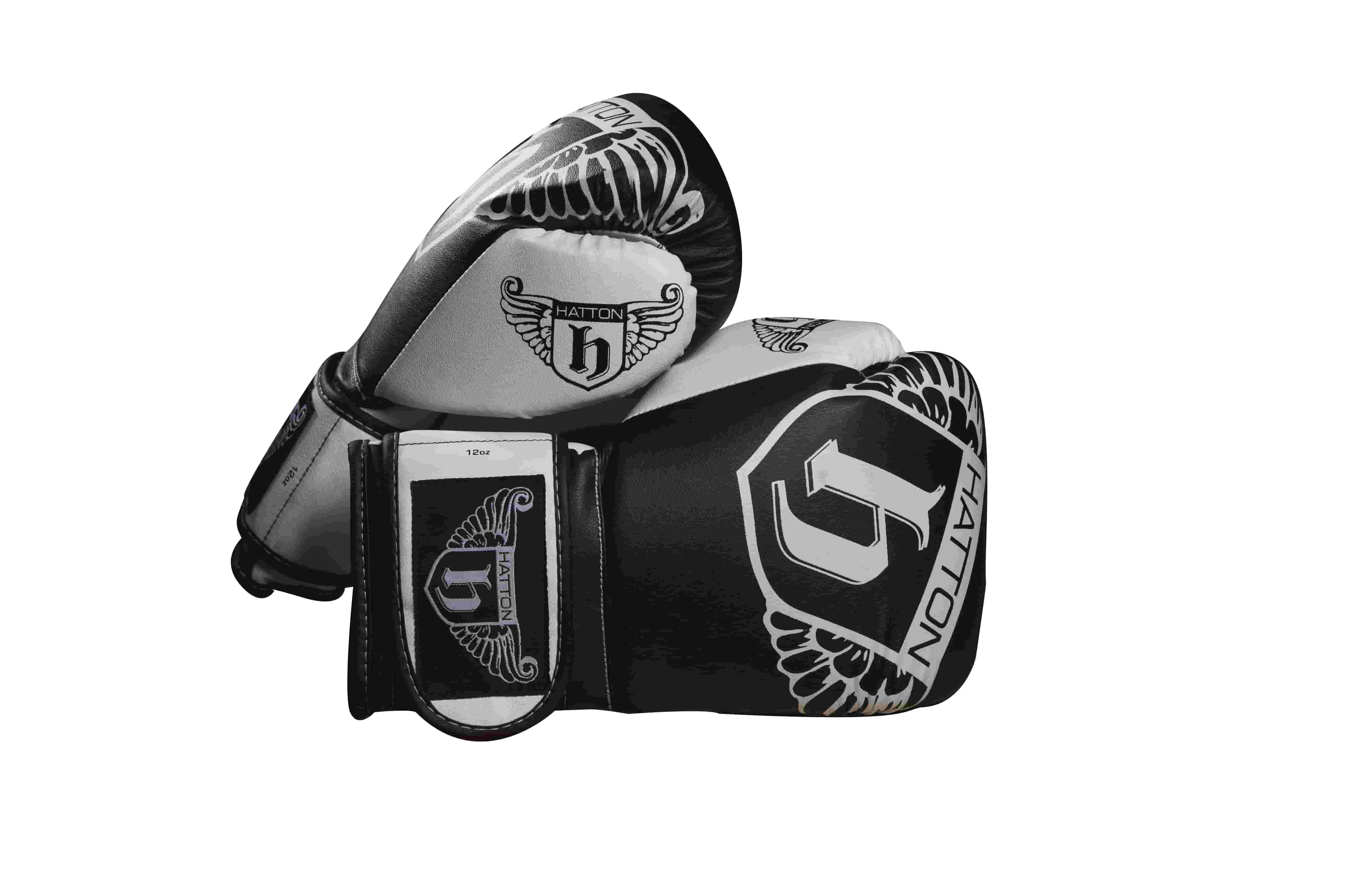 A pair of black and white boxing gloves with the brand name Hatton and decorative winged logos printed on them, displayed against a white background.