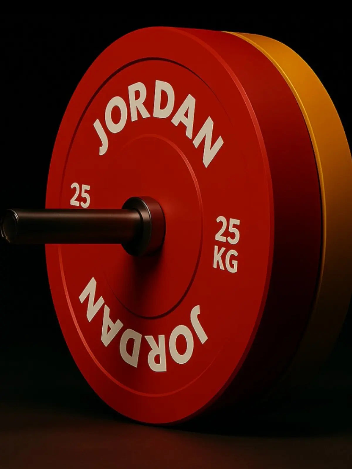 A close-up of a red 25 kg weight plate labeled JORDAN on a barbell, with a yellow weight plate partially visible in the background against a dark backdrop.