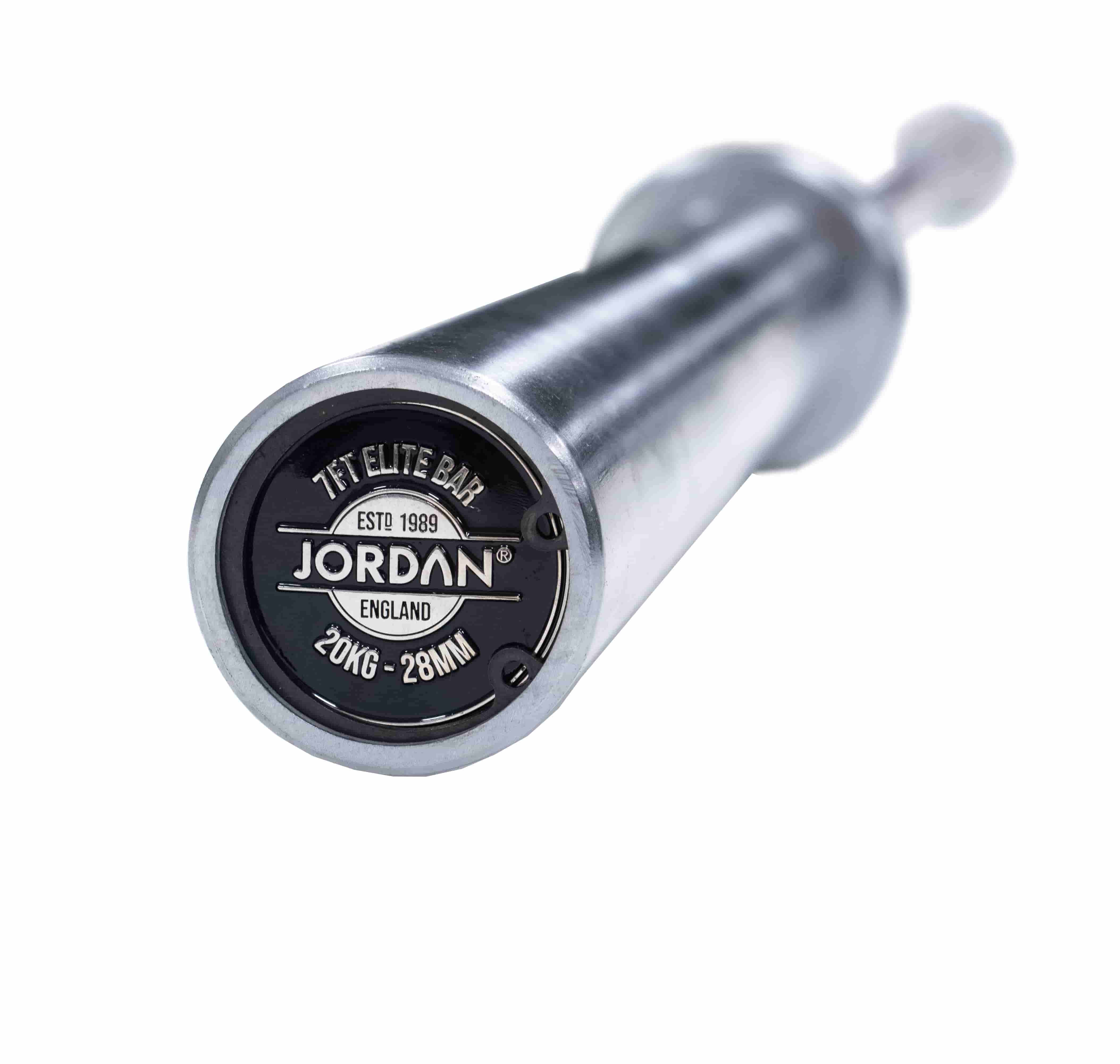 Close-up of the end of a silver barbell engraved with TFT Elite Bar, Jordan England, 20KG - 28MM, and ESTD 1989 on a black circular cap.