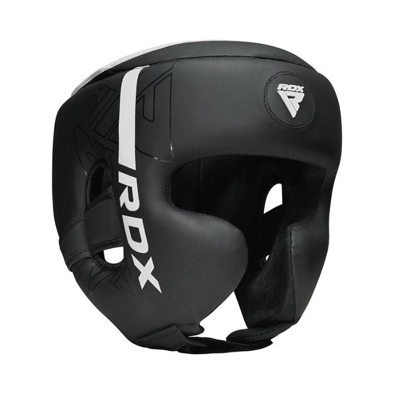A black RDX boxing headguard with white branding and a white top stripe, shown from a three-quarters angle on a plain white background.