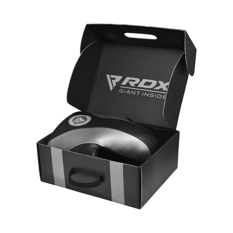A black and silver RDX branded boxing body protector is displayed inside an open black RDX box with the slogan "GIANT INSIDE" on the inner lid.