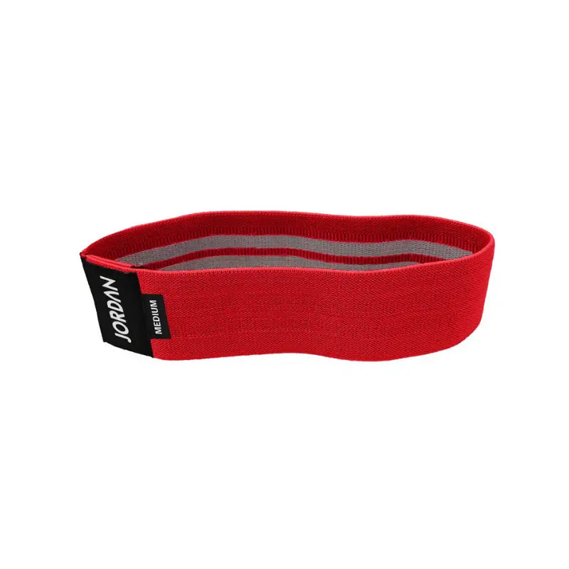 The JORDAN Fabric Resistance Band is a non-slip booty band for squats, lunges, and glute workouts. Shown in red with a black Jordan Medium label against a white background.