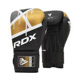A pair of RDX boxing gloves in black, gold, and white, featuring a modern design with white diagonal lines and gold accents. The RDX logo is prominently displayed on the wrist straps and glove surface.